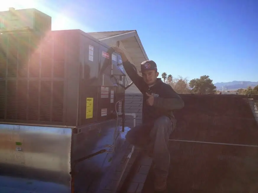 HVAC technician performing HVAC Inspection on a rooftop unit in Wilkins
